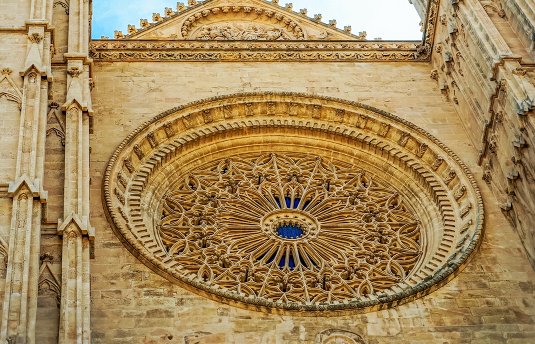 Rose window at Palma Cathedral with intricate stained glass design, Majorca.