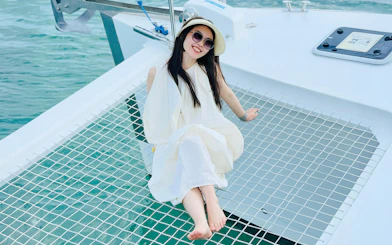 Woman relaxing on a jacuzzi net during Langkawi Sunset Cruise.