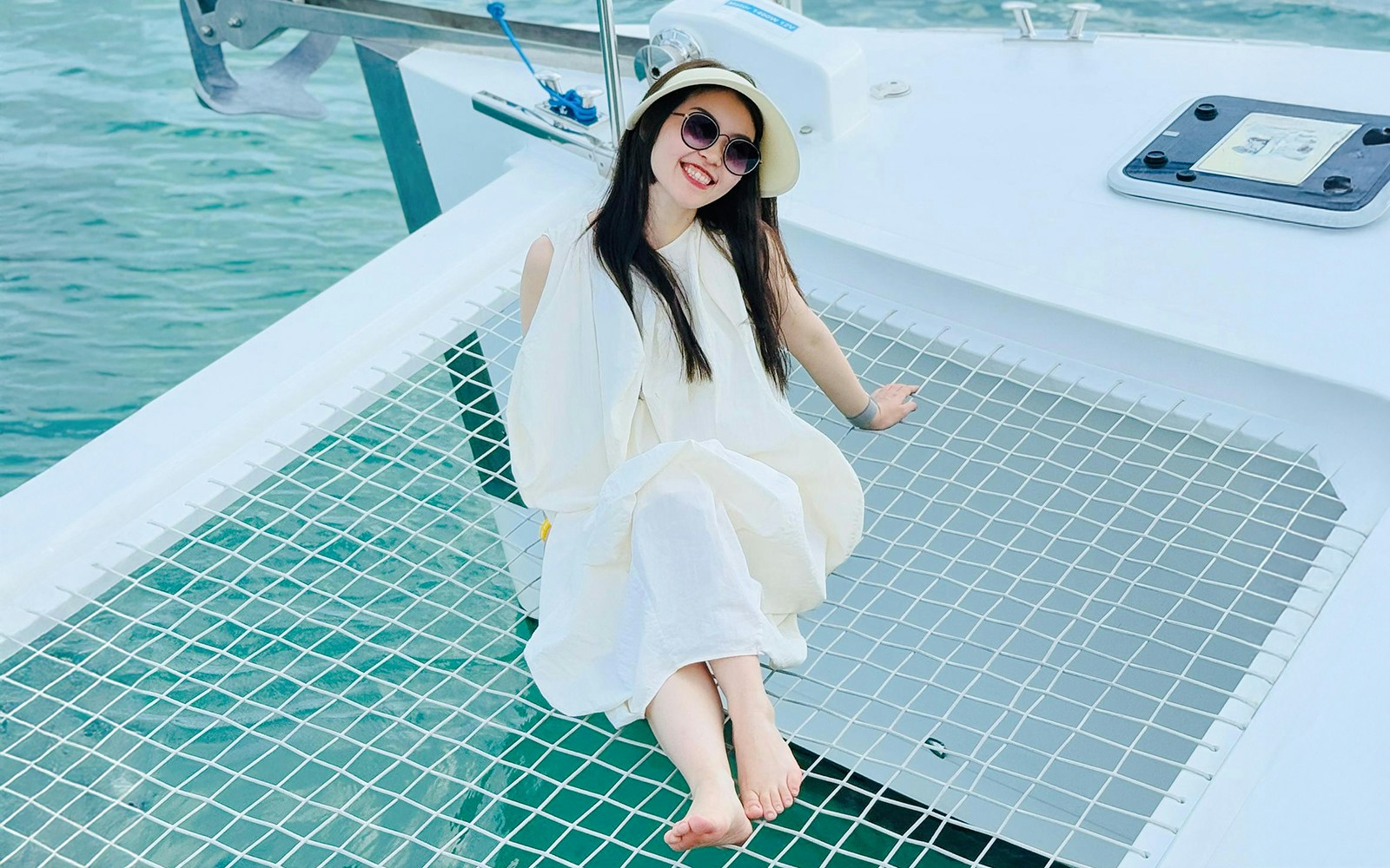 Woman relaxing on jacuzzi net during Langkawi Sunset Cruise with scenic ocean view.
