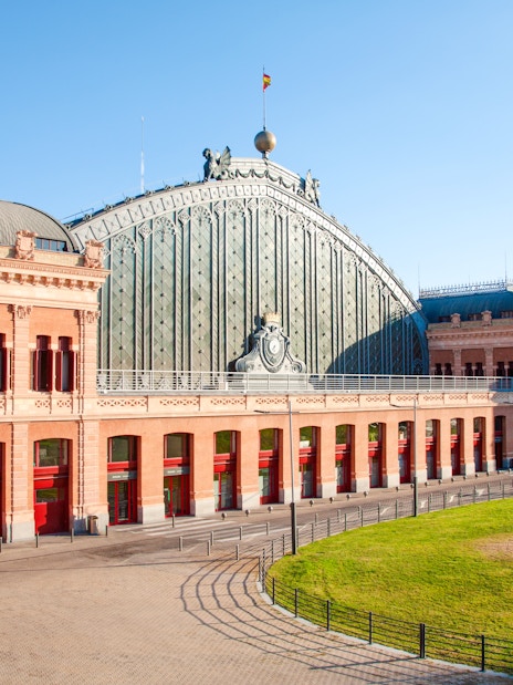 Facade of Madrid Atocha train station with red brick and arched windows, Madrid.