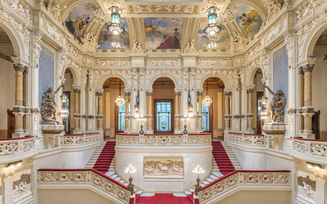 Interiors of QC Terme San Pellegrino Resort & Spa in Bergamo with ornate staircase and frescoed ceiling.
