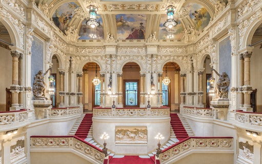 Interiors of QC Terme San Pellegrino Resort & Spa in Bergamo with ornate staircase and frescoed ceiling.