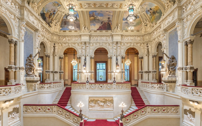 Interiors of QC Terme San Pellegrino Resort & Spa in Bergamo with ornate staircase and frescoed ceiling.