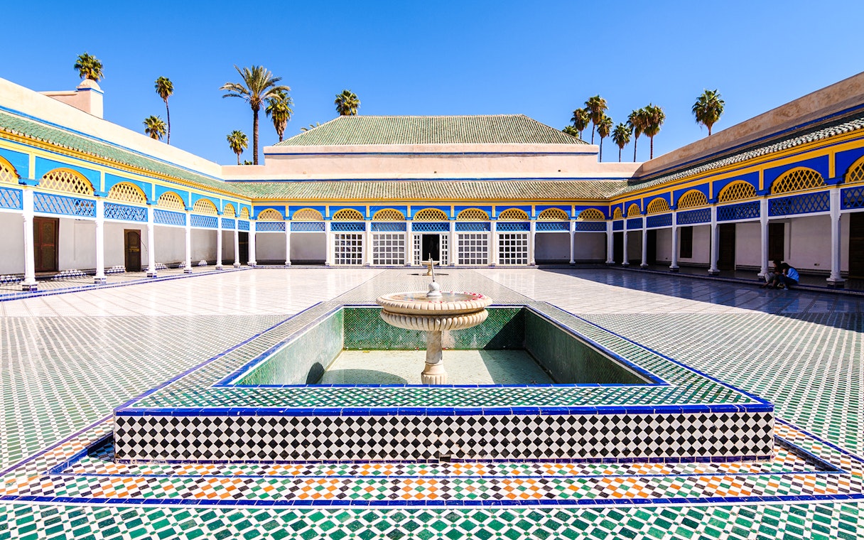 Bahia Palace courtyard with fountain and colorful tilework in Marrakech, Morocco.