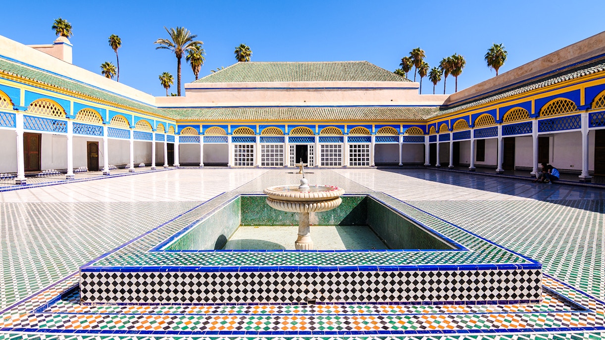 Bahia Palace courtyard with fountain and colorful tilework in Marrakech, Morocco.