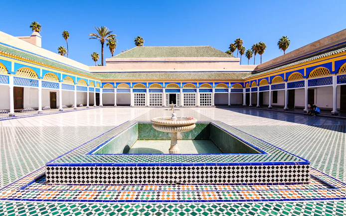 Bahia Palace courtyard with fountain and colorful tilework in Marrakech, Morocco.