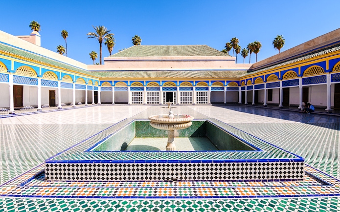 Bahia Palace courtyard with fountain and colorful tilework in Marrakech, Morocco.