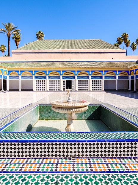 Bahia Palace courtyard with fountain and colorful tilework in Marrakech, Morocco.