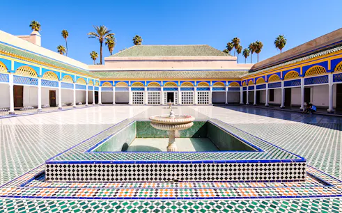 Bahia Palace courtyard with fountain and colorful tilework in Marrakech, Morocco.