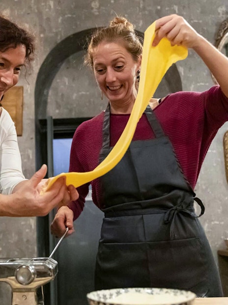 Participants making fettuccine in a pasta class in Trastevere, Rome.