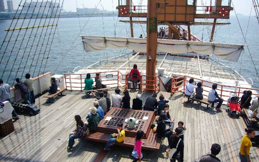 Passengers on the Santa Maria cruise ship deck enjoying Osaka Bay views.