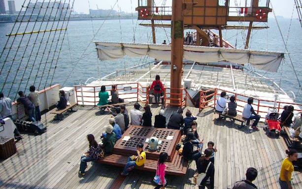 Passengers on the Santa Maria cruise ship deck enjoying Osaka Bay views.