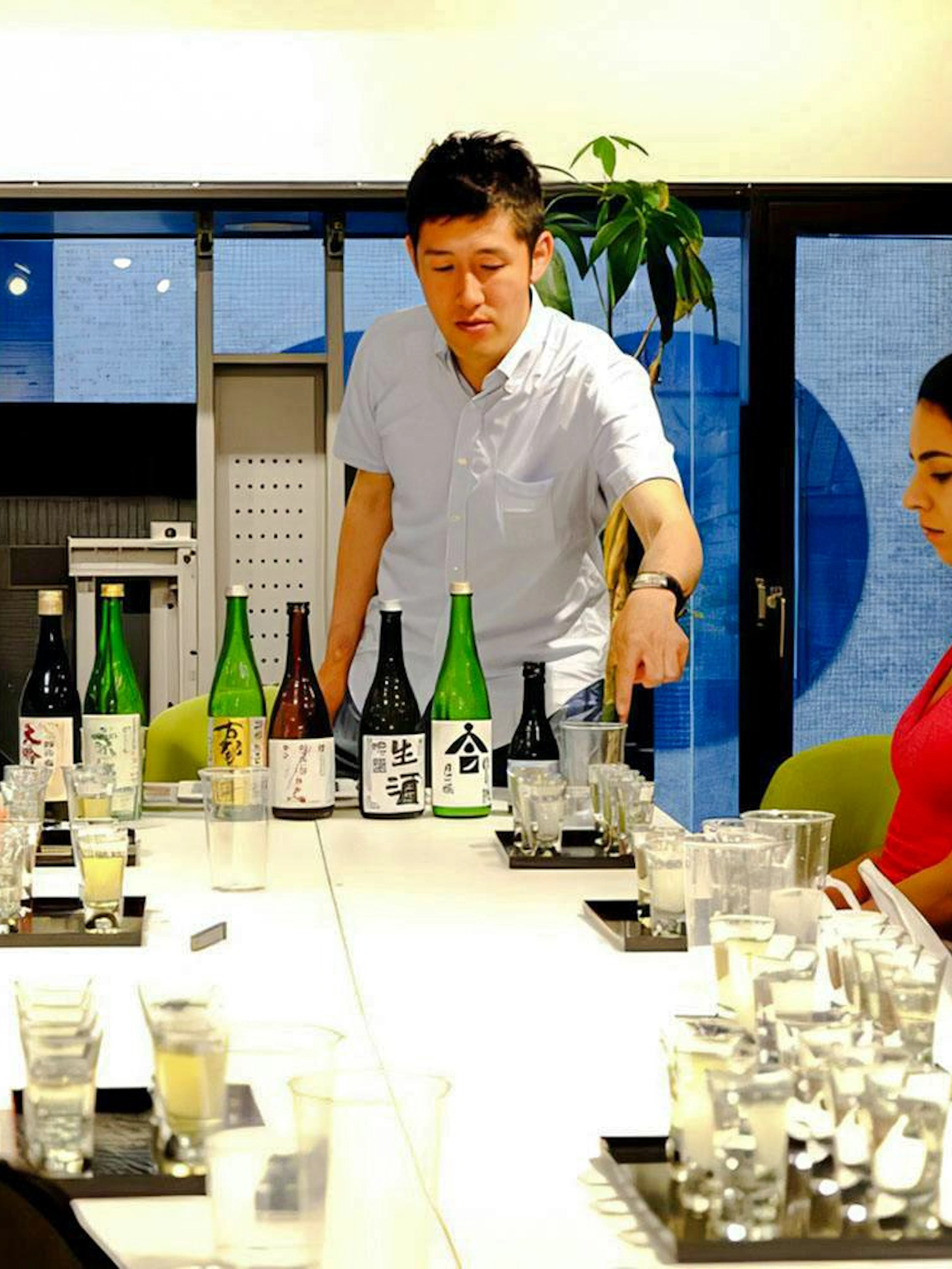Sake tasting session at Kyoto Insider Sake Experience with bottles displayed on the table.