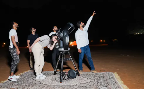 Group stargazing with telescope at Mleiha Space Camp, UAE.