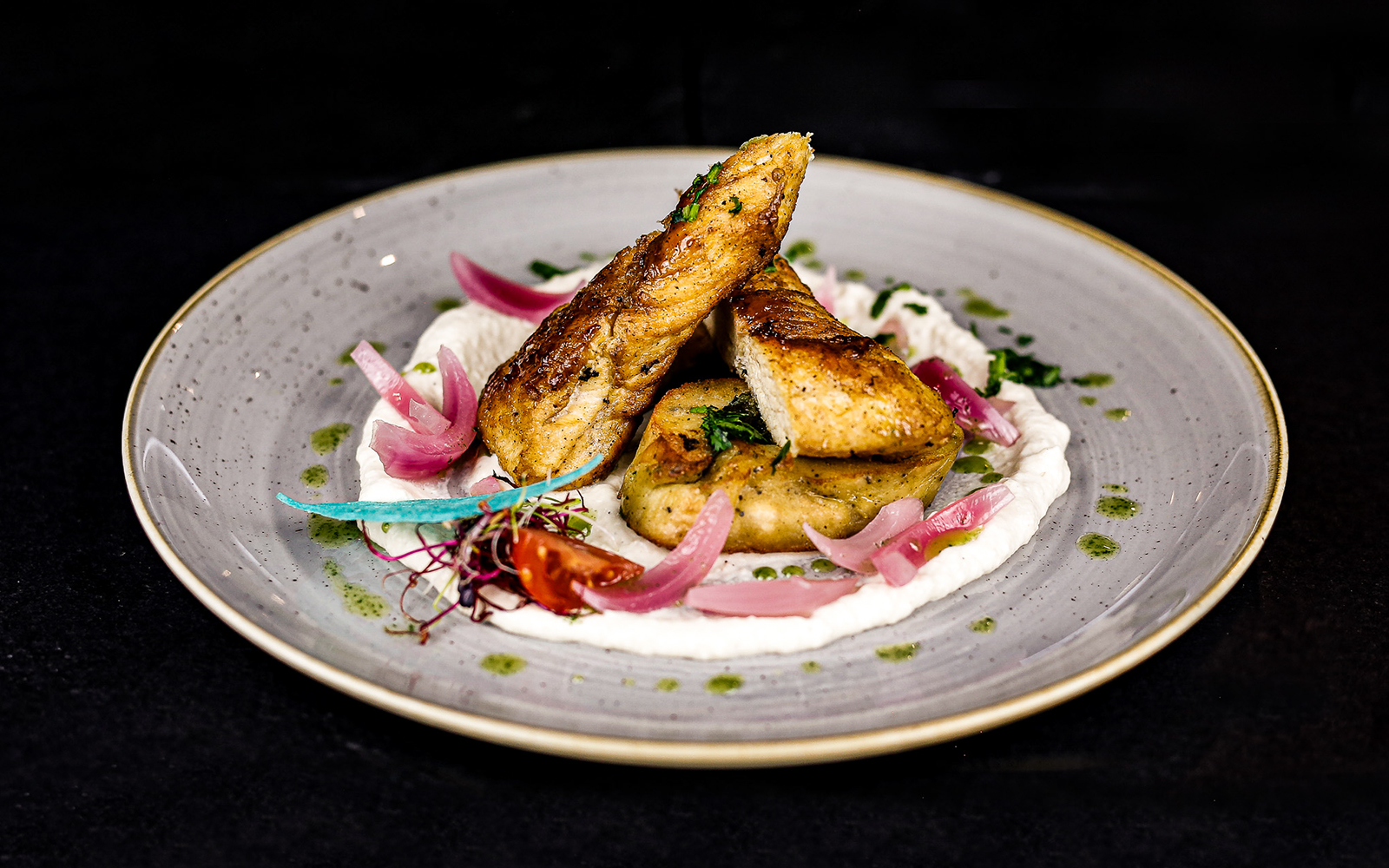 Chicken breast, bread dumpling with spinach and pickled red onion on new york lunch Dinner Cruise