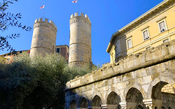 Medieval towers and stone arches near Columbus' House in Genoa, Italy.