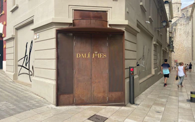 Entrance of Dalí Theatre-Museum in Figueres, Catalonia, Spain, with distinctive brown doors.