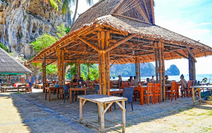 Bamboo restaurant by the beach at Tonsai Bay with diners enjoying the view.