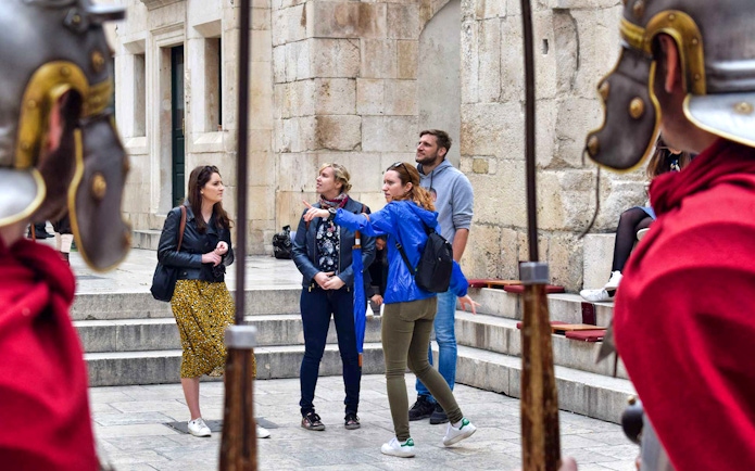 Tour guide leading a group through Diocletian's Palace in Split, Croatia.