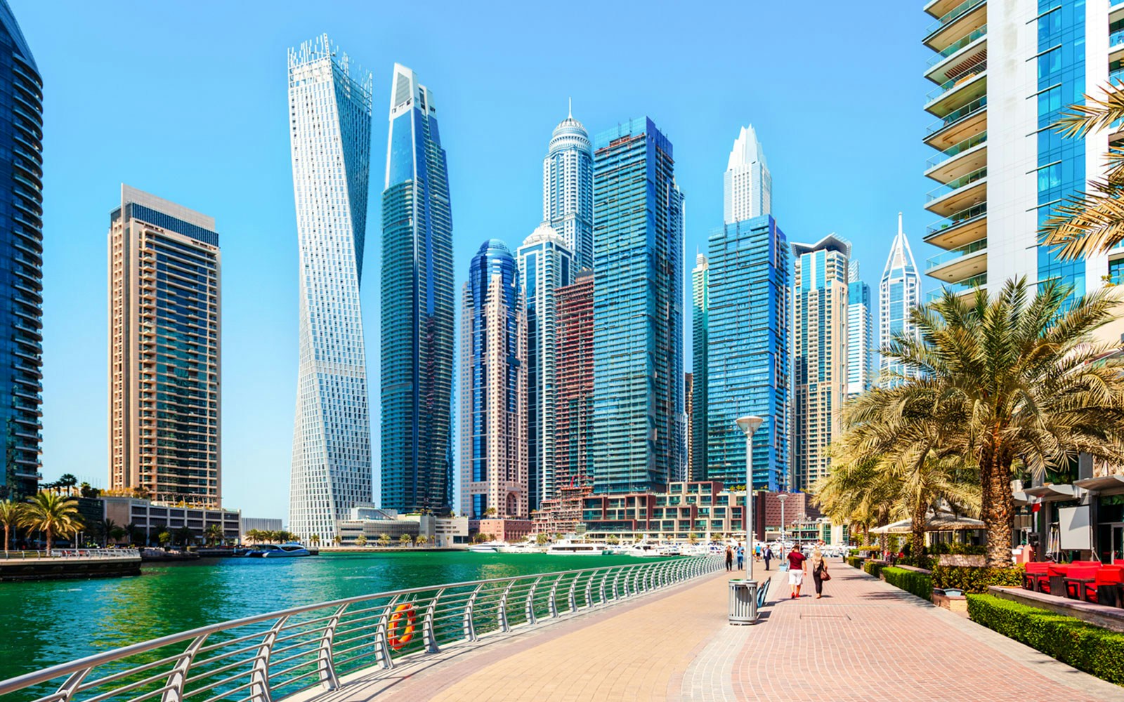 Dubai Marina Walk with skyscrapers and waterfront promenade.