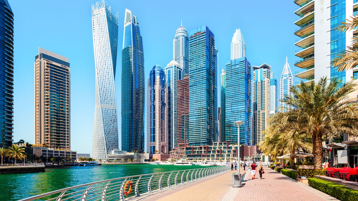 Dubai Marina Walk with skyscrapers and waterfront promenade.