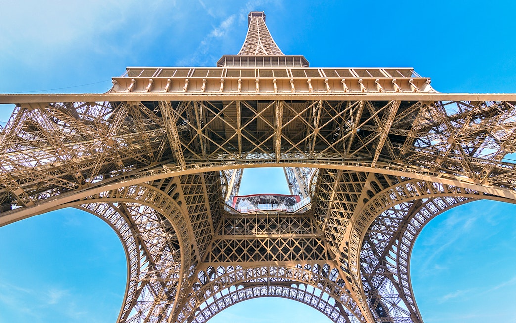 Eiffel Tower view from below, showcasing iron lattice structure, Paris.