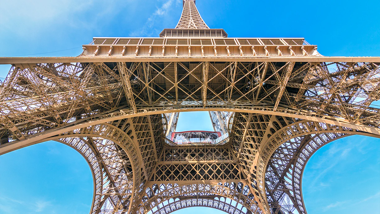 Eiffel Tower view from below, showcasing iron lattice structure, Paris.