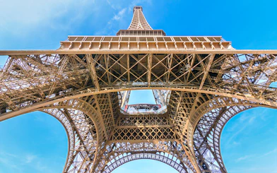 Eiffel Tower view from below, showcasing iron lattice structure, Paris.