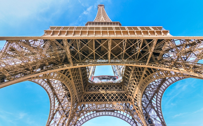 Eiffel Tower view from below, showcasing iron lattice structure, Paris.