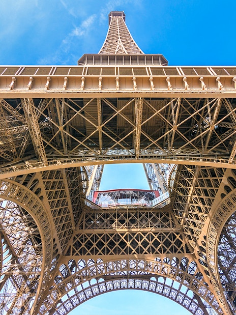 Eiffel Tower view from below, showcasing iron lattice structure, Paris.