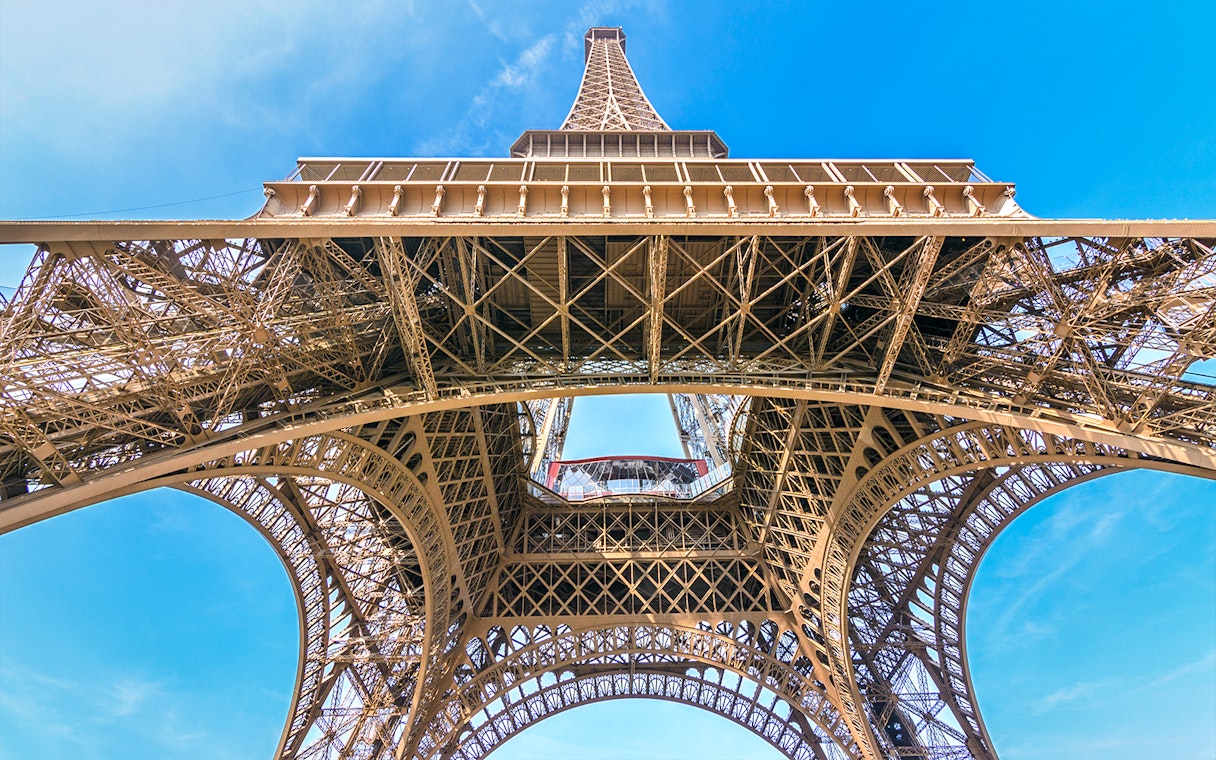 Eiffel Tower view from below, showcasing iron lattice structure, Paris.