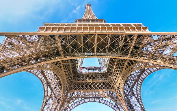 Eiffel Tower view from below, showcasing iron lattice structure, Paris.