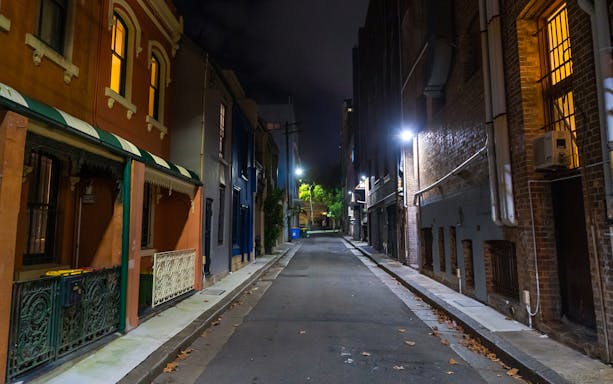 Dimly lit alleyway in Sydney, Australia, highlighting historic Razor Gang crime tour route.