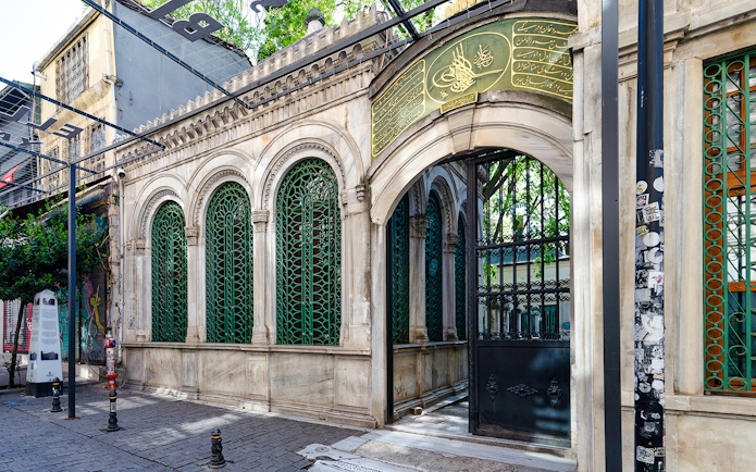 Galata Mevlevihanesi Museum entrance with ornate green ironwork, Istanbul.