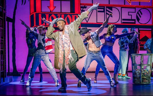 Performers dancing energetically on stage in Pretty Woman The Musical.