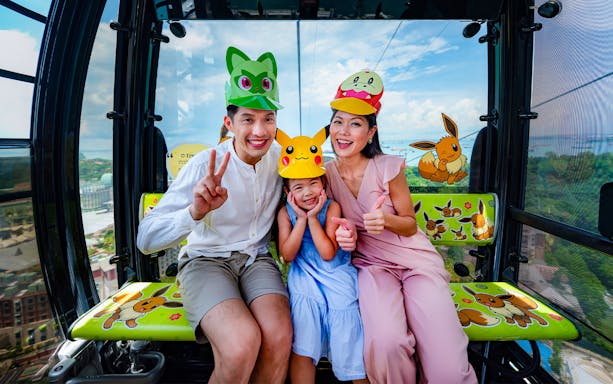 Family enjoying Singapore Cable Car ride with themed hats.