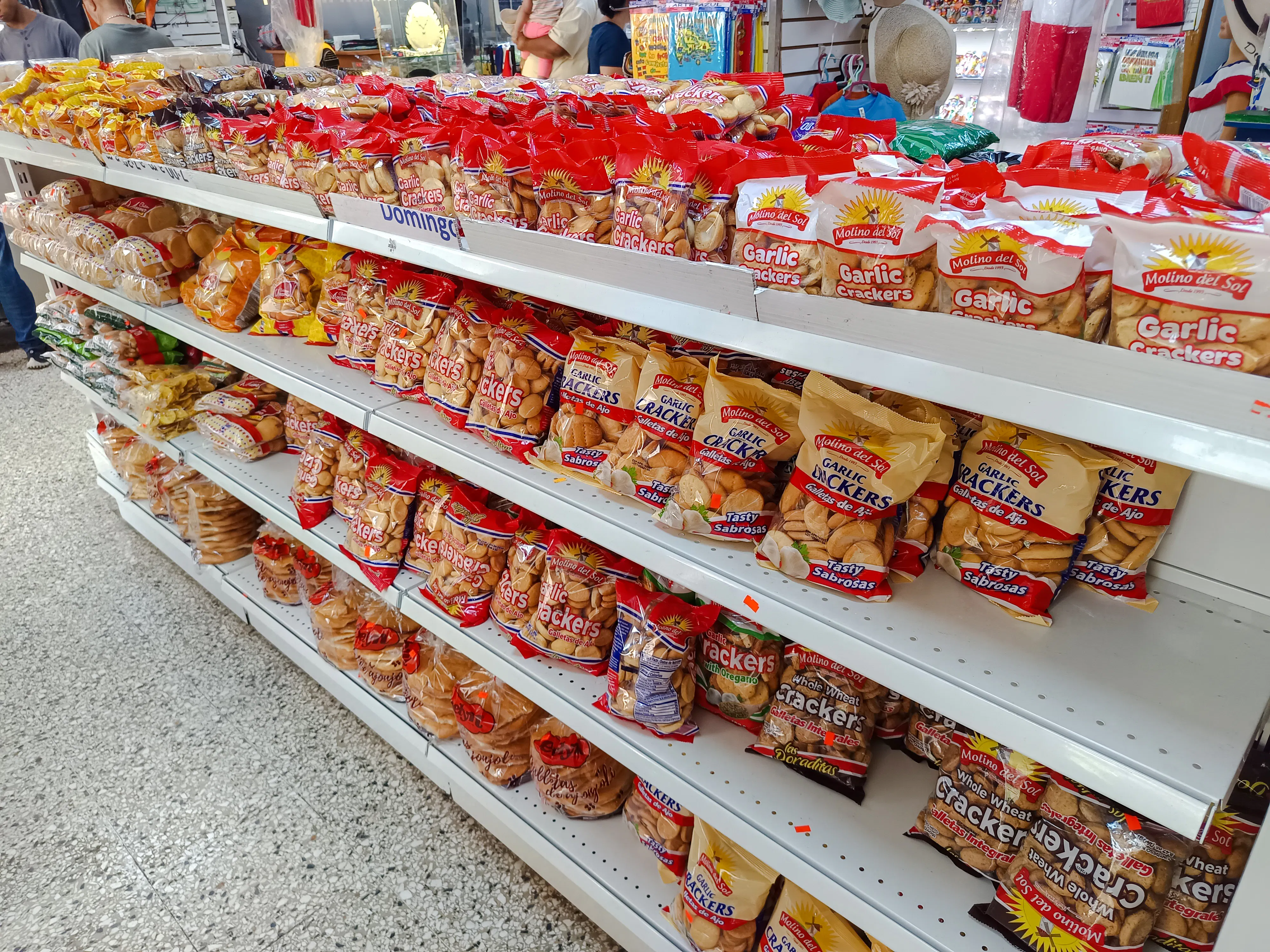Shelves of garlic crackers at Mercado Modelo, Santo Domingo, during a food walking tour.