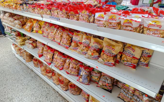 Shelves of garlic crackers at Mercado Modelo, Santo Domingo, during a food walking tour.
