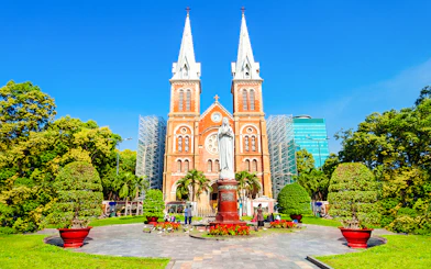 Saigon Notre Dame Cathedral Basilica with statue and gardens in Ho Chi Minh City.