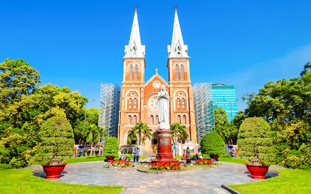 Saigon Notre Dame Cathedral Basilica with statue and gardens in Ho Chi Minh City.