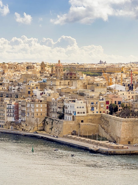 Aerial view of the Three Fortified Cities in Malta with boats in the harbor.