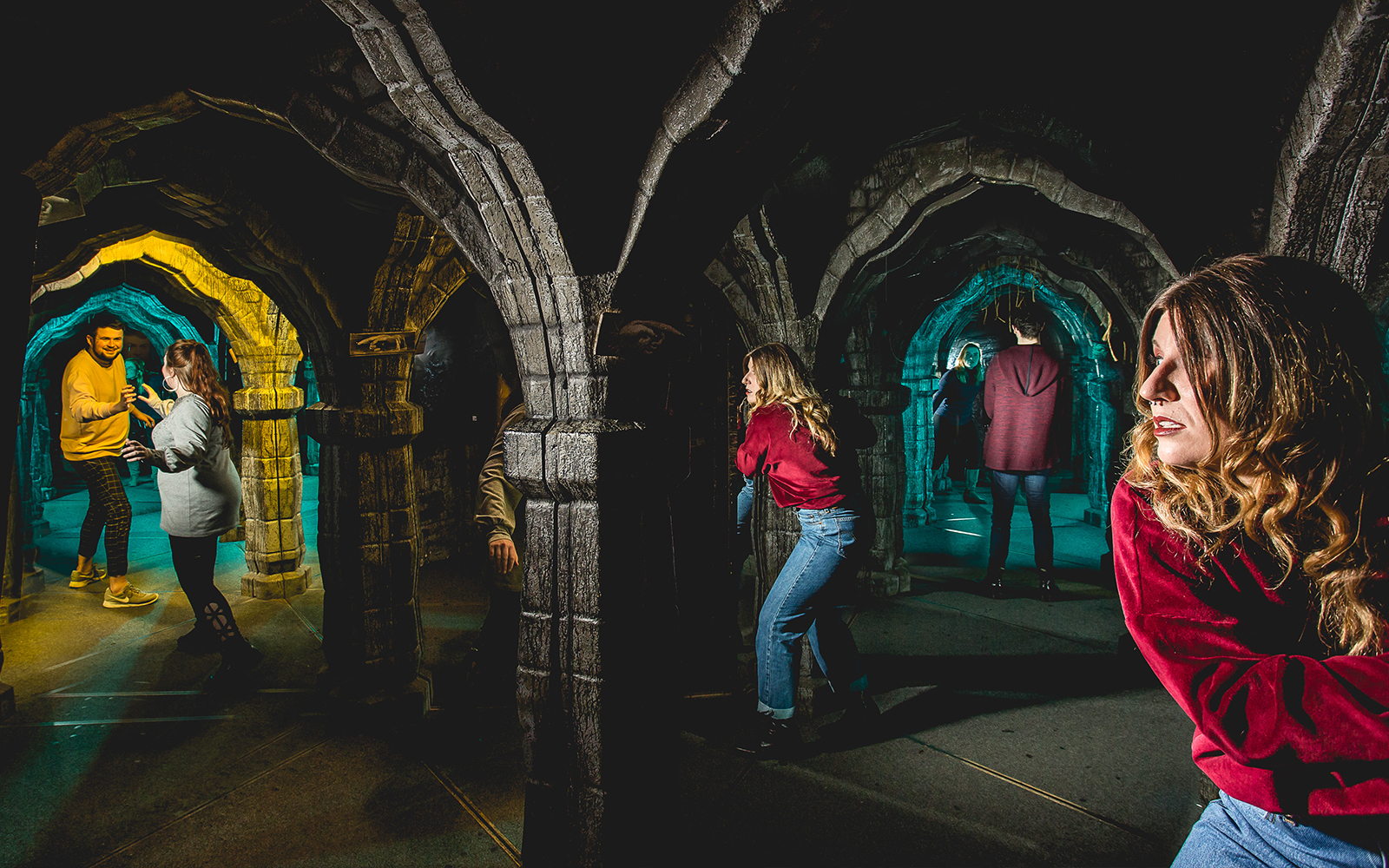 Visitors exploring the mirror maze at Edinburgh Dungeon.