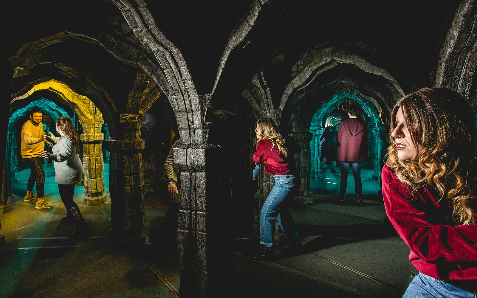 Visitors exploring the mirror maze at Edinburgh Dungeon.