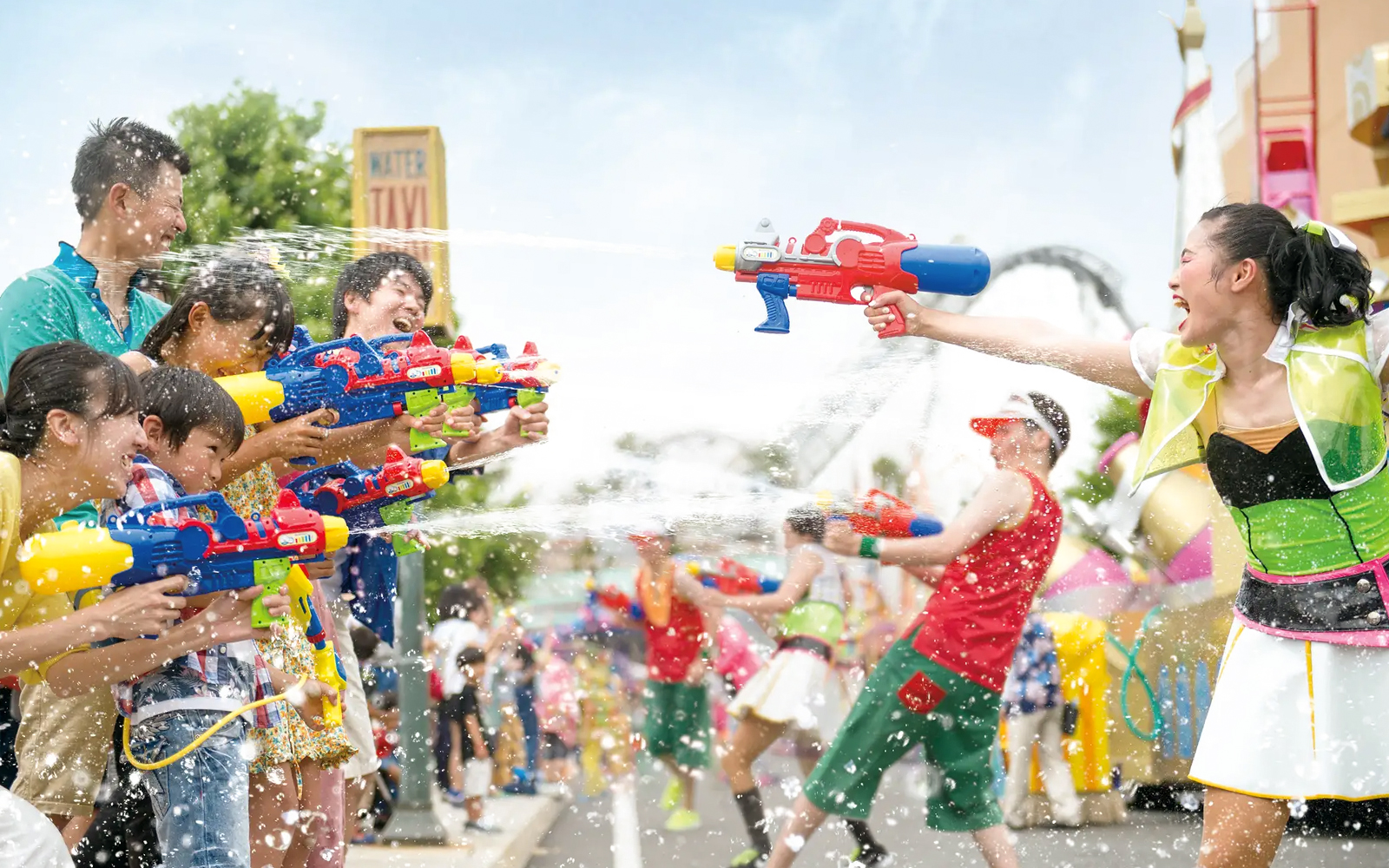 Visitors engaging in water gun battle during Summer Splash Parade at Universal Studios Japan.