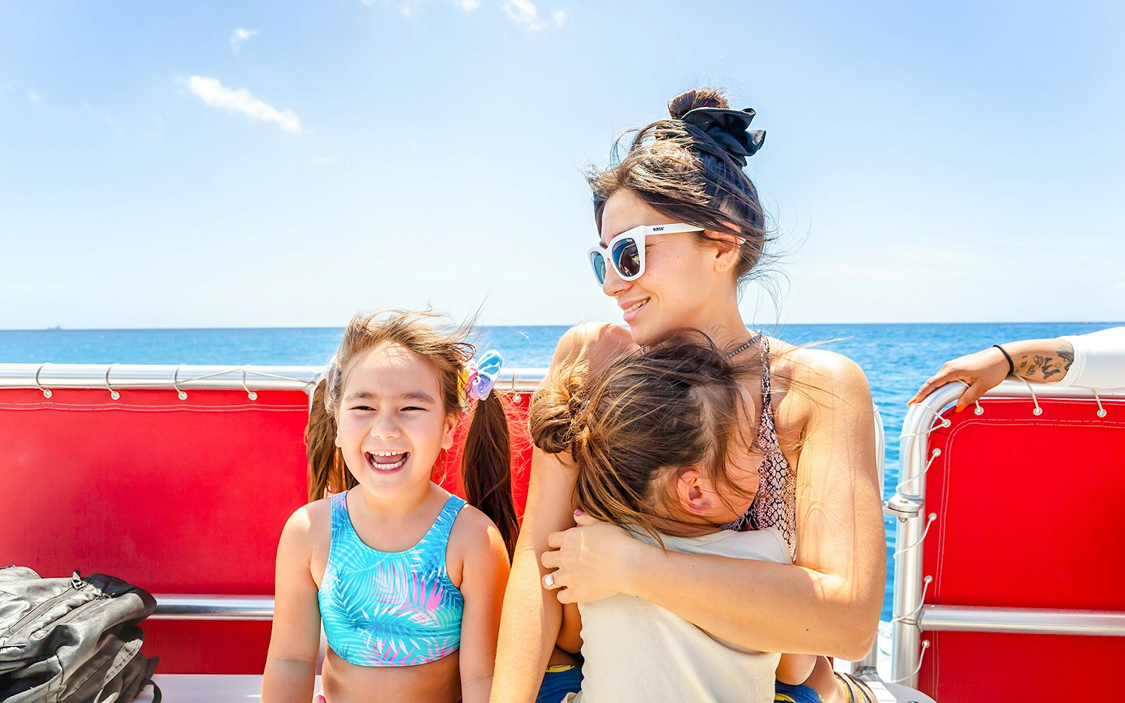 Guests enjoying a Hawaii glass-bottom boat tour with ocean view.
