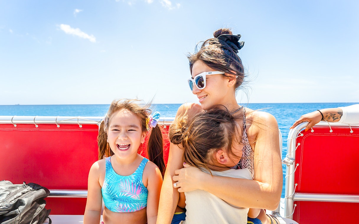 Guests enjoying a Hawaii glass-bottom boat tour with ocean view.