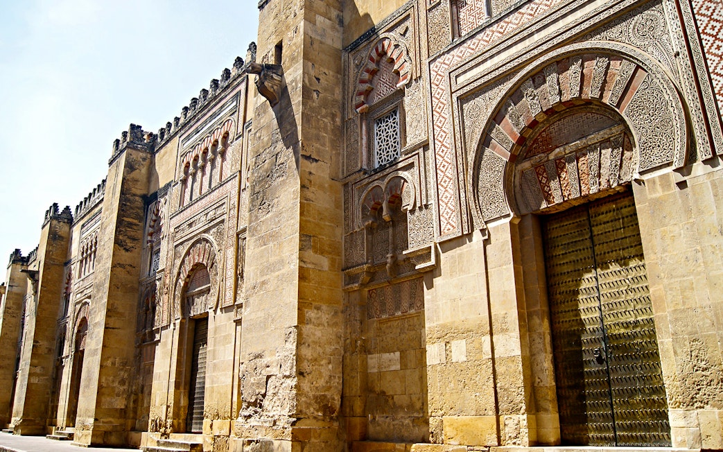Cordoba Mosque-Cathedral exterior with intricate arches and detailed stonework.