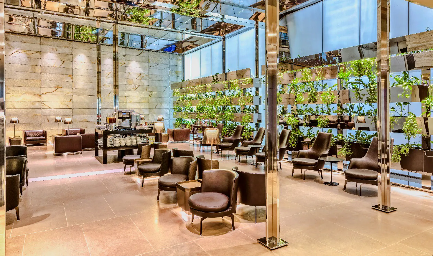 Al Maha Lounge seating area with plants at Doha Hamad International Airport.
