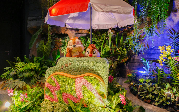 Chip and Dale topiary under umbrella in Disney Garden of Wonder.