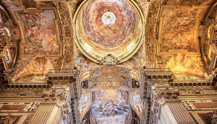 Vatican Grottoes with visitors exploring historic tombs beneath St. Peter's Basilica, Vatican City.